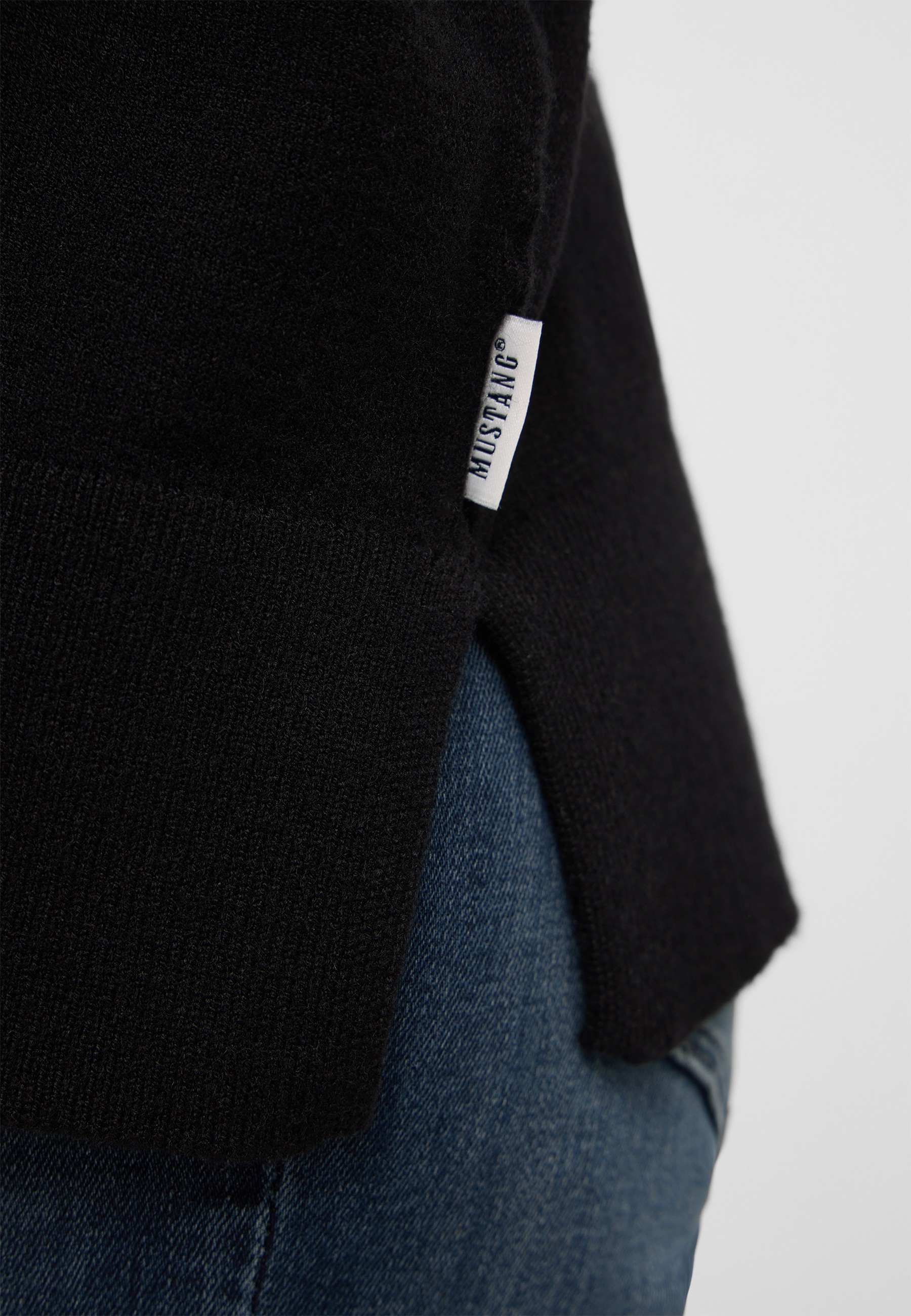 t-shirt tag, small tag, black sweater, side slit, jeans