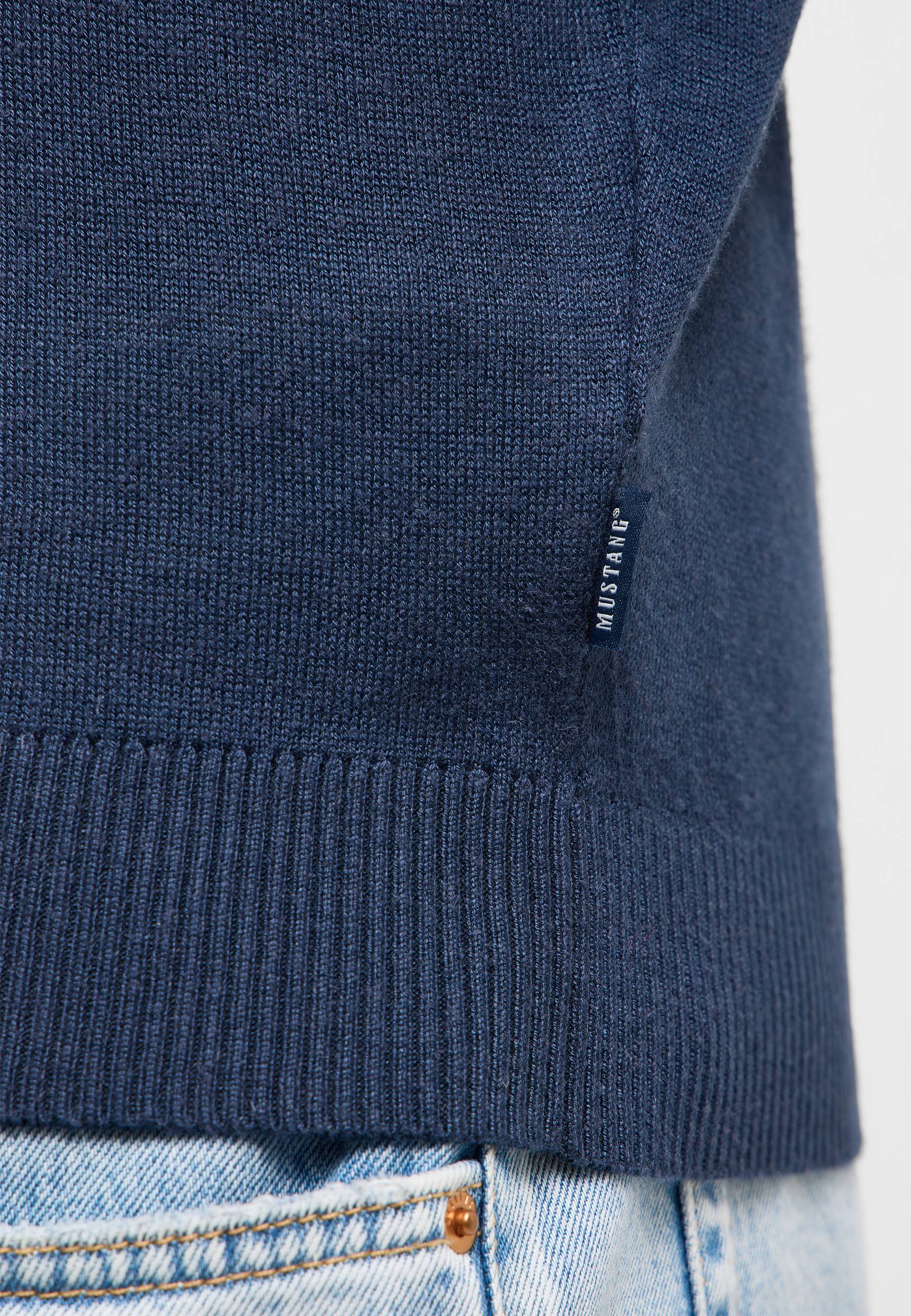 navy knit, sweater hem, ribbed edge, tag, denim jeans